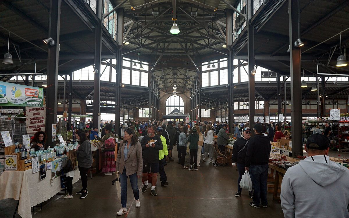 A diverse crowd of shoppers and vendors inside Detroit's Eastern Market.